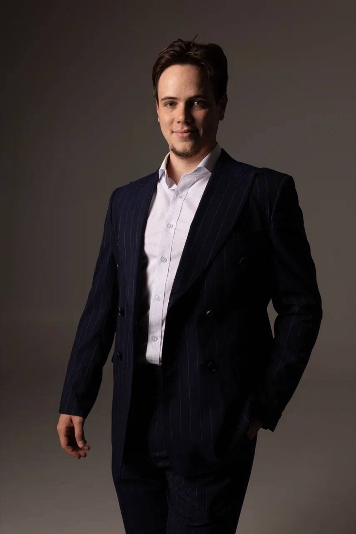 Nikita Simakov in a dark suit
